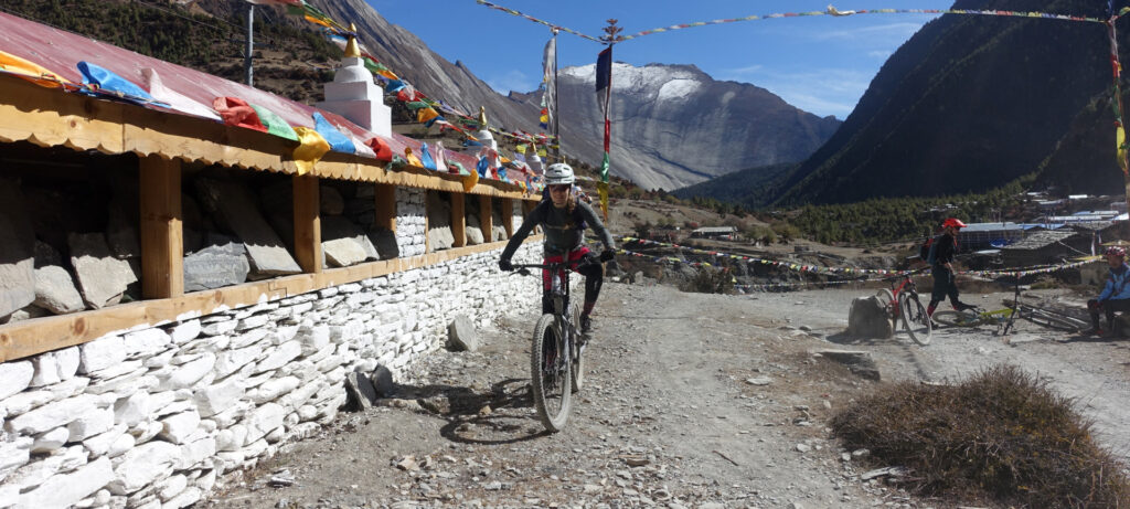 A mountain biker in Nepal with Himalayas behind