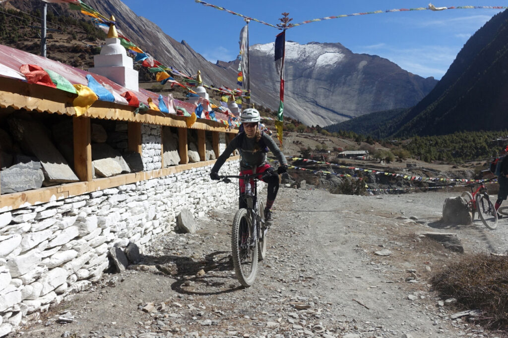 A mountain biker in Nepal with Himalayas behind